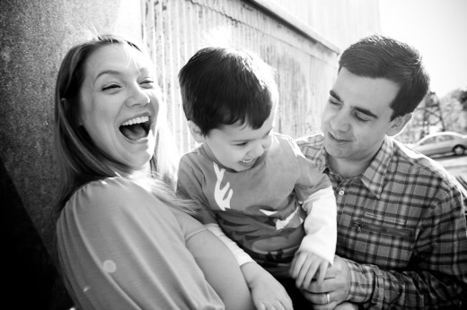 The family laughing at something obviously hilarious... probably Isaac.