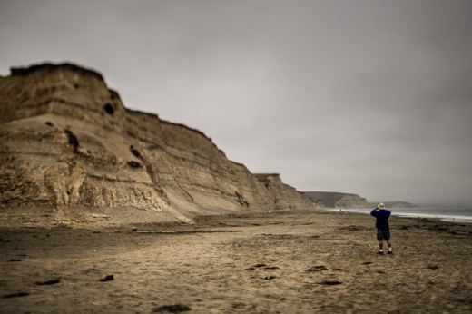 Getting the shot--a man photographs the Drake's Beach cliffs.